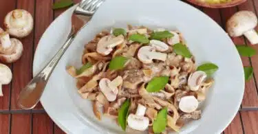 pasta with mushroom with leaves on plate
