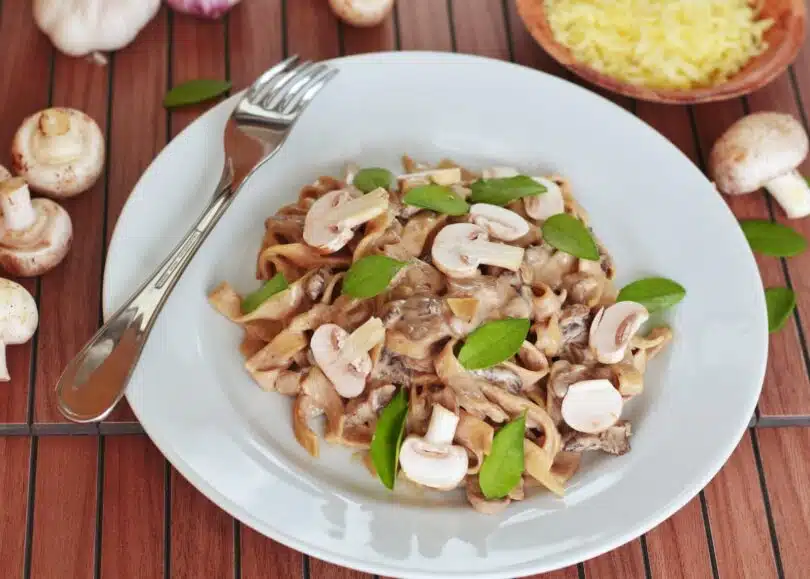 pasta with mushroom with leaves on plate